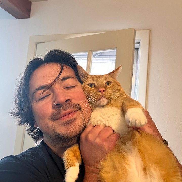 RoyDan hugging an orange cat