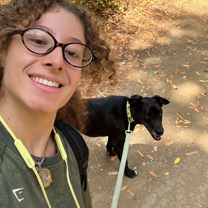 Suari on a trail walk with a black dog